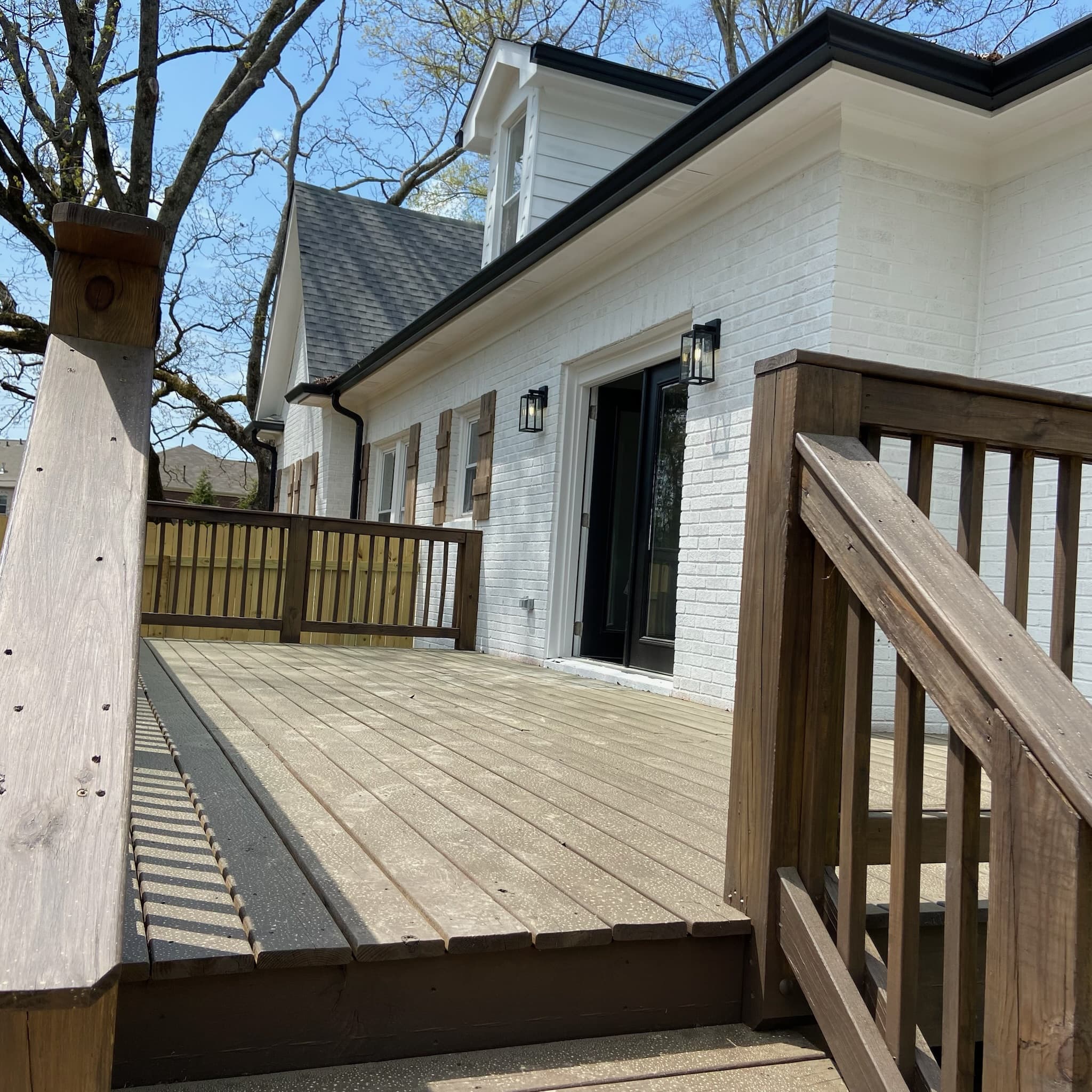 Custom deck with white brick exterior